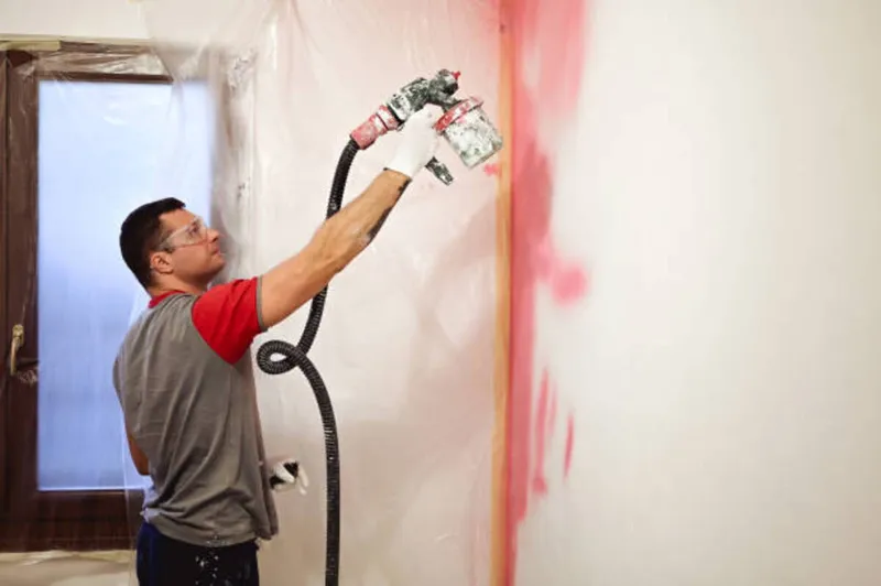 Interior spray painting during a new construction project in Ottawa