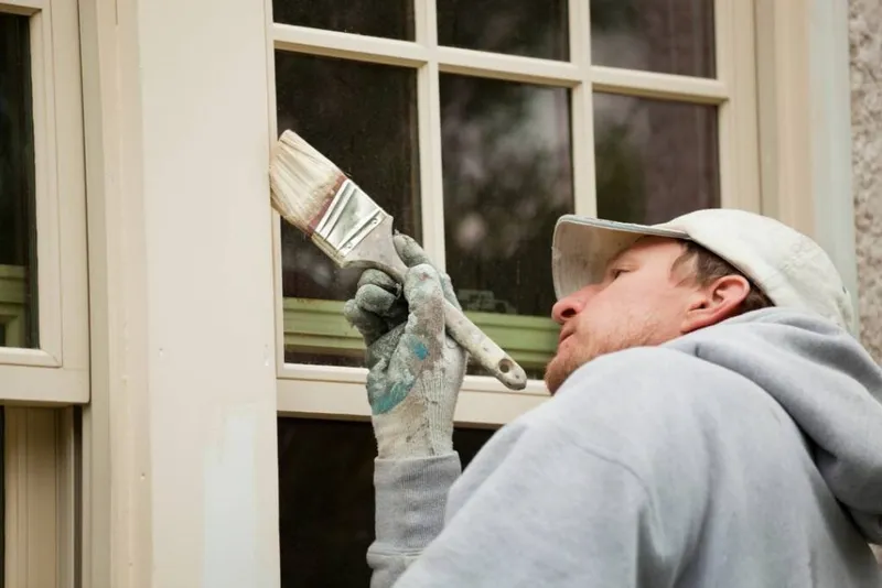 Window frames being painted on an Ottawa property